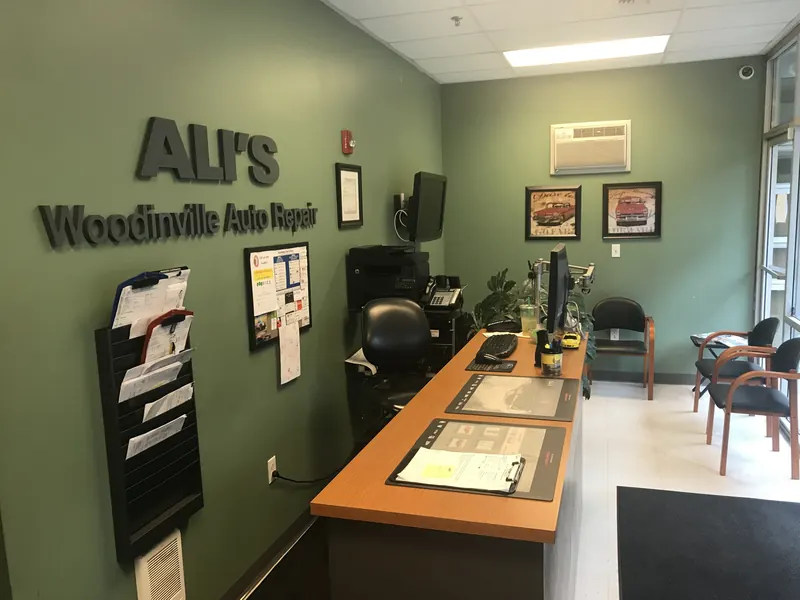 The shop's front desk and waiting area under the ALI'S sign